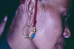 Traditional heavy gold jewellery, and elongated hole in ear lobe.
